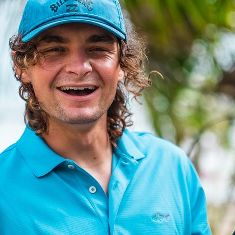 Chris Faber, Sea Clear co-owner, smiling in a Sea Clear polo under the palms